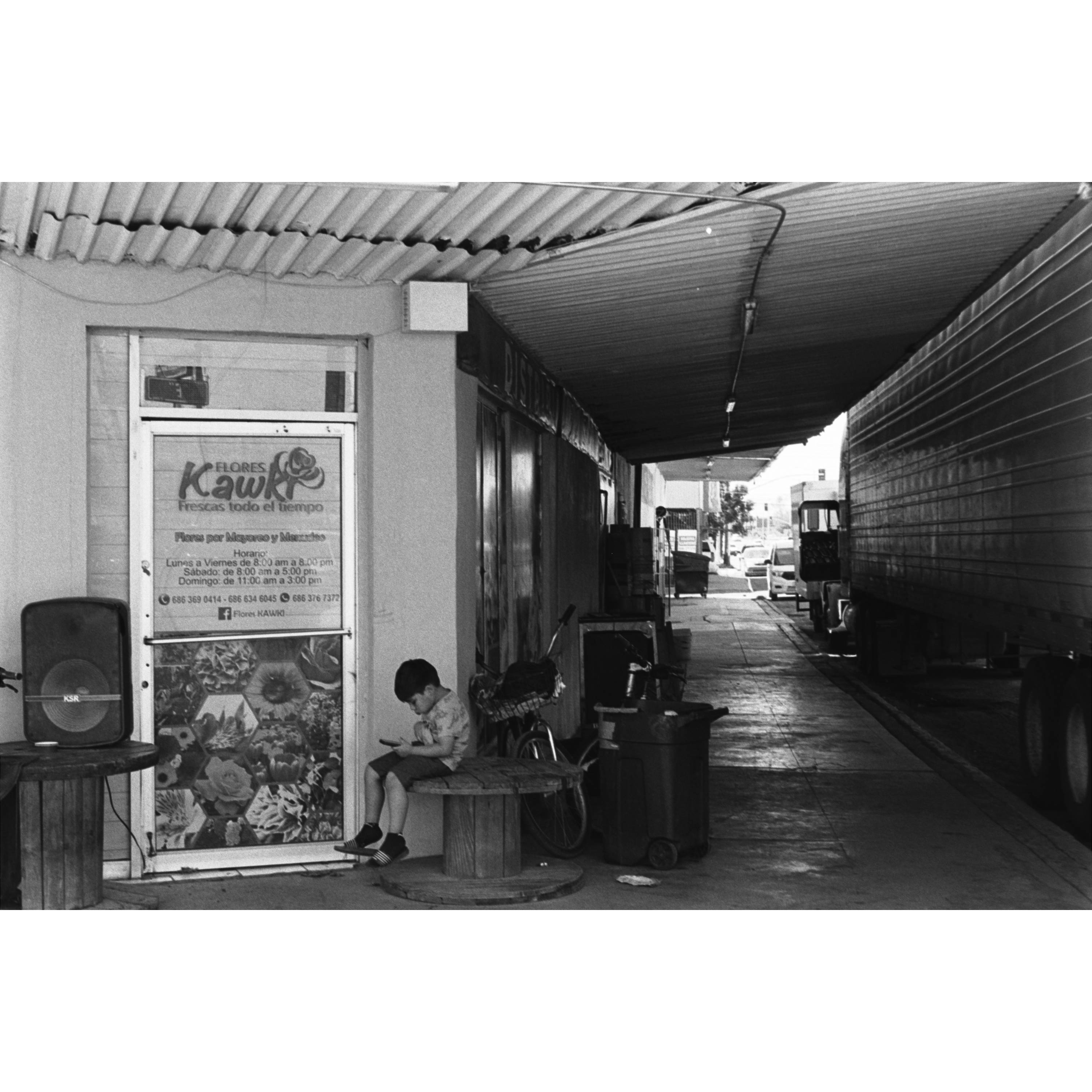 Boy in front of flower shop
