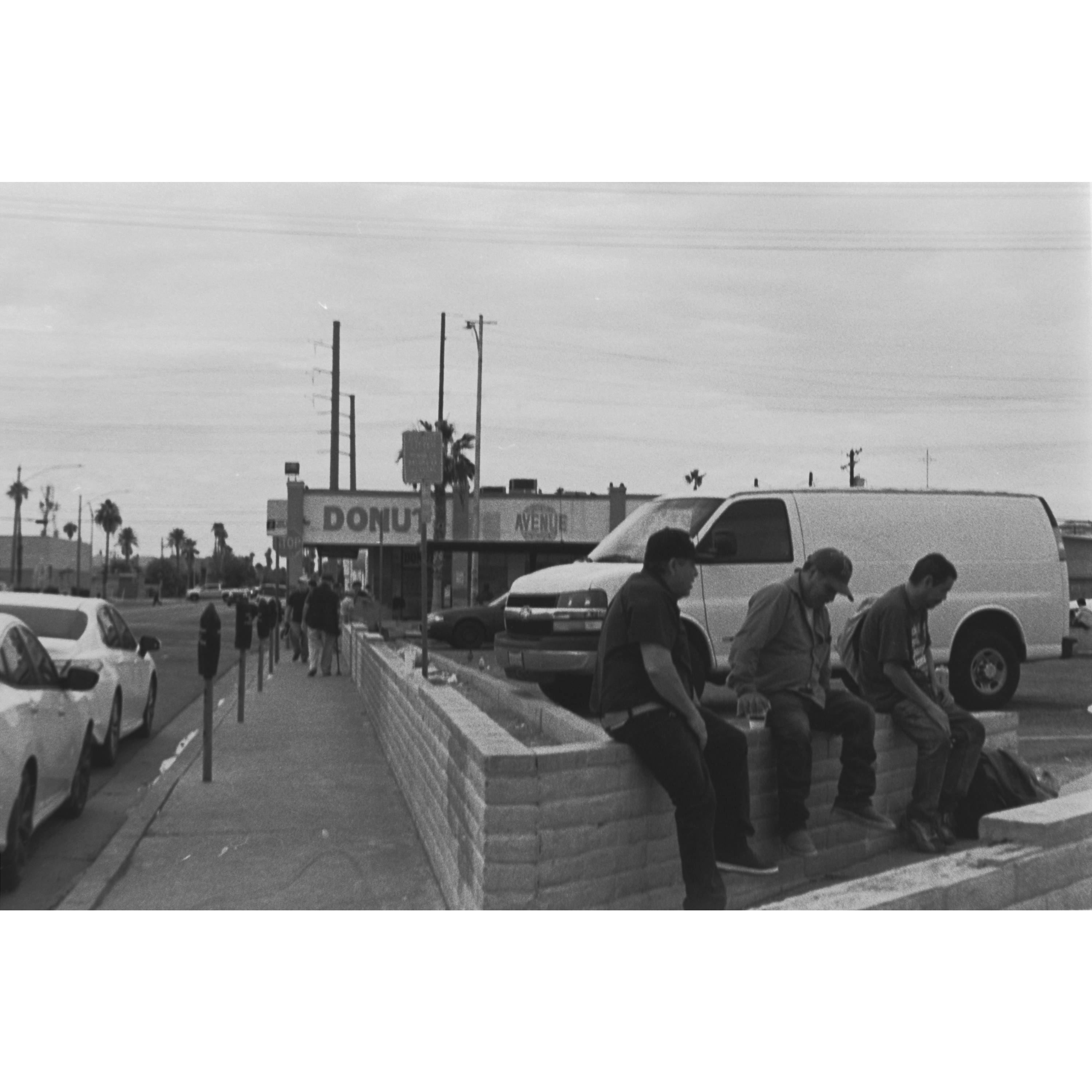 Three men sitting near the border